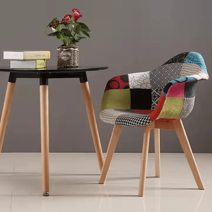 Garden Chair Bring a perfect blend of mid-century style and modern comfort to your indoor or outdoor space with the Arm Rest Patch Garden Eames Chair. Inspired by the iconic Eames design, this chair features a molded polypropylene seat in a vibrant patchwork fabric finish, combined with ergonomic armrests and a contoured shape for all-day comfort. The colorful, eye-catching upholstery adds a unique artistic flair, making it a standout piece in any setting—be it your garden, patio, balcony, living room, or office. Built on solid wooden legs reinforced with a black steel Eiffel-style base, this Eames-style armchair offers both stability and style. The supportive armrests and cushioned seat make it ideal for relaxing, reading, or entertaining guests. Whether you're creating a cozy reading corner or enhancing your outdoor lounging area, the Garden Eames Chair with armrest and patchwork design brings a bold and stylish statement to your décor. Weather-resistant materials make it suitable for light outdoor use, while the easy-to-clean fabric ensures low maintenance. This chair combines iconic design, comfort, and versatility—perfect for anyone who appreciates functional art in their living spaces. Key Features Iconic Eames-Inspired Design Mid-century modern silhouette with a colorful patchwork fabric seat and smooth, ergonomic curves. Comfortable Armrests Molded armrests offer extra support and comfort, ideal for prolonged seating. Sturdy Wooden Legs Natural wood legs with Eiffel-style black metal cross supports provide strength and stability. Vibrant Patchwork Upholstery Multicolor fabric patch design adds a creative, artistic touch to indoor or garden spaces. Versatile Usage Perfect for indoor use and light outdoor settings such as patios, balconies, or covered gardens. Ergonomic & Supportive Contoured seat design promotes good posture and comfortable lounging. Easy to Clean & Maintain Durable, stain-resistant fabric wipes clean easily with a damp cloth. Quick Assembly Includes all necessary tools and instructions for a fast, simple setup.